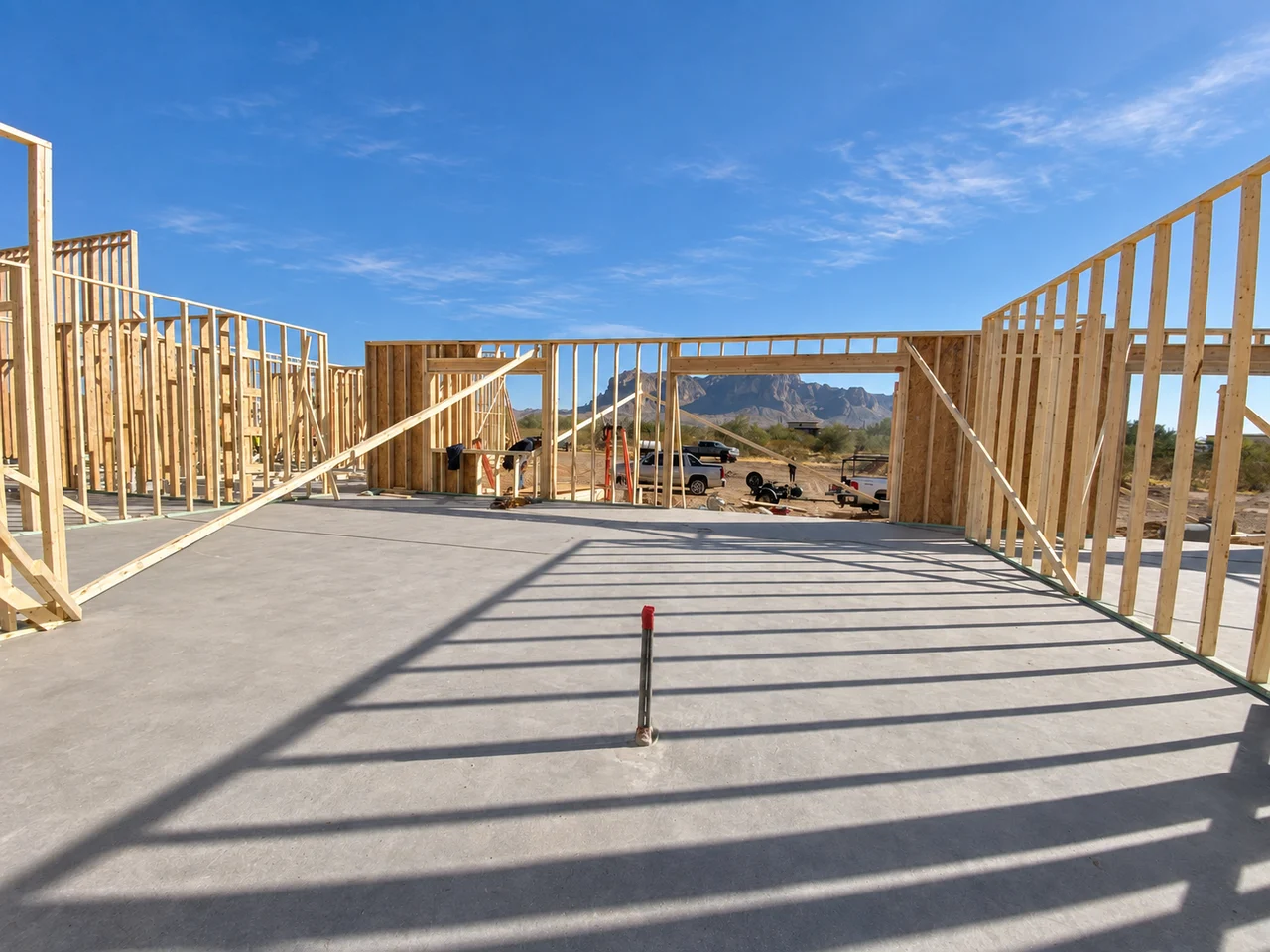 Timber framing of a SUNdearA custom home, with the Arizona mountains framed by its future windows